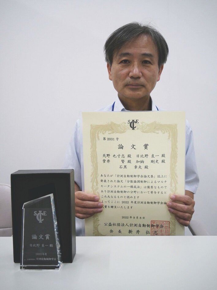 賞状を手にする日比野教授